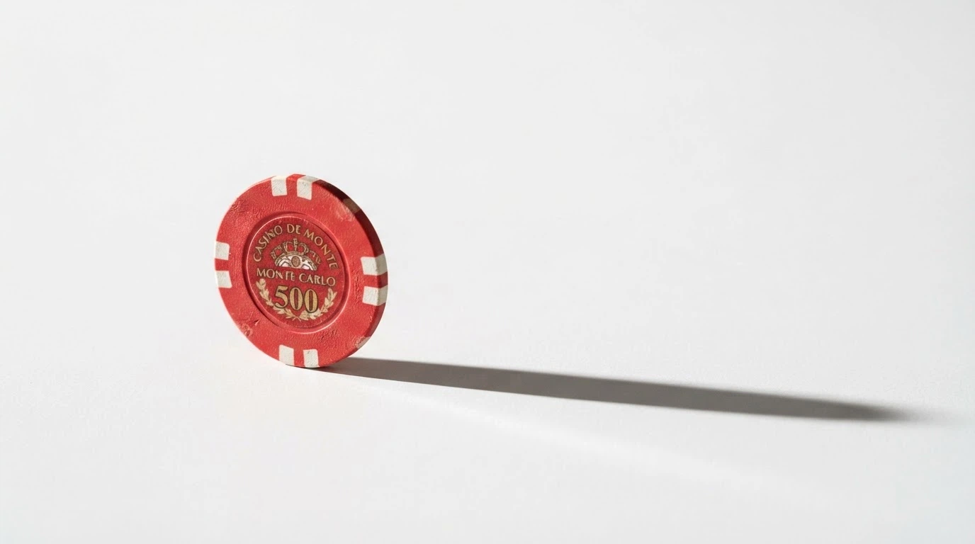 A single Australian one-dollar coin on a plain surface, with a shadow stretching long behind it — the coin is real but small against the space around it